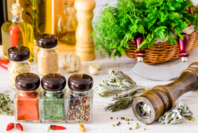 Spices, food seasoning pepper mill and green herbs. paprika, thyme and parsley
