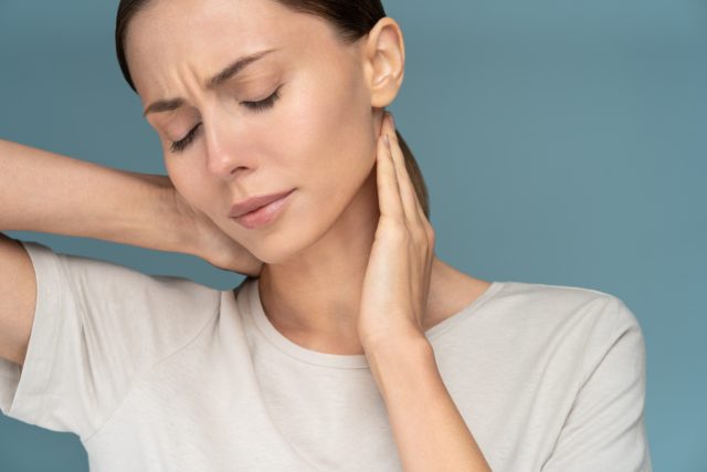 Woman suffering from chronic neck pain