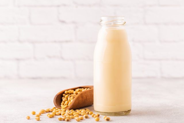 A bottle of soy milk and soy beans